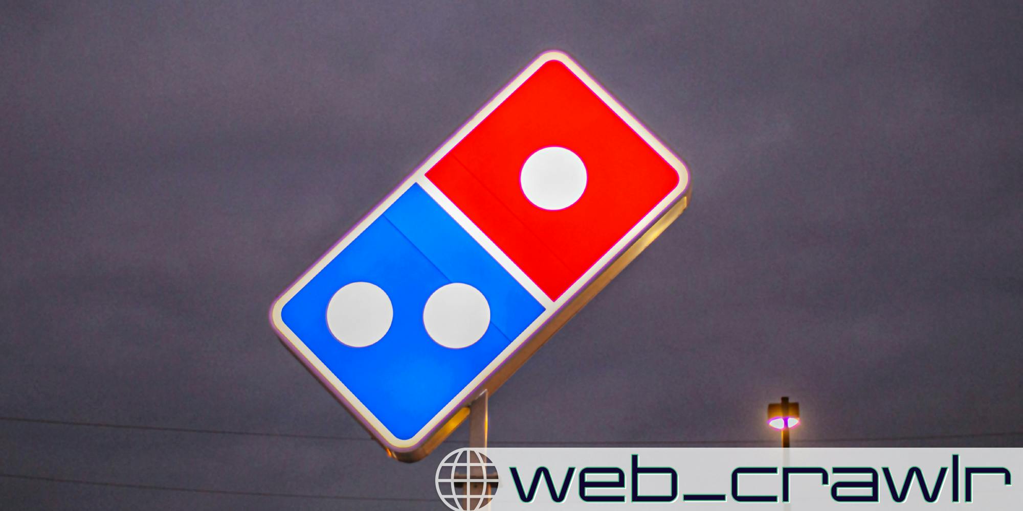 A Domino's Pizza sign. The Daily Dot newsletter web_crawlr logo is in the bottom right corner.