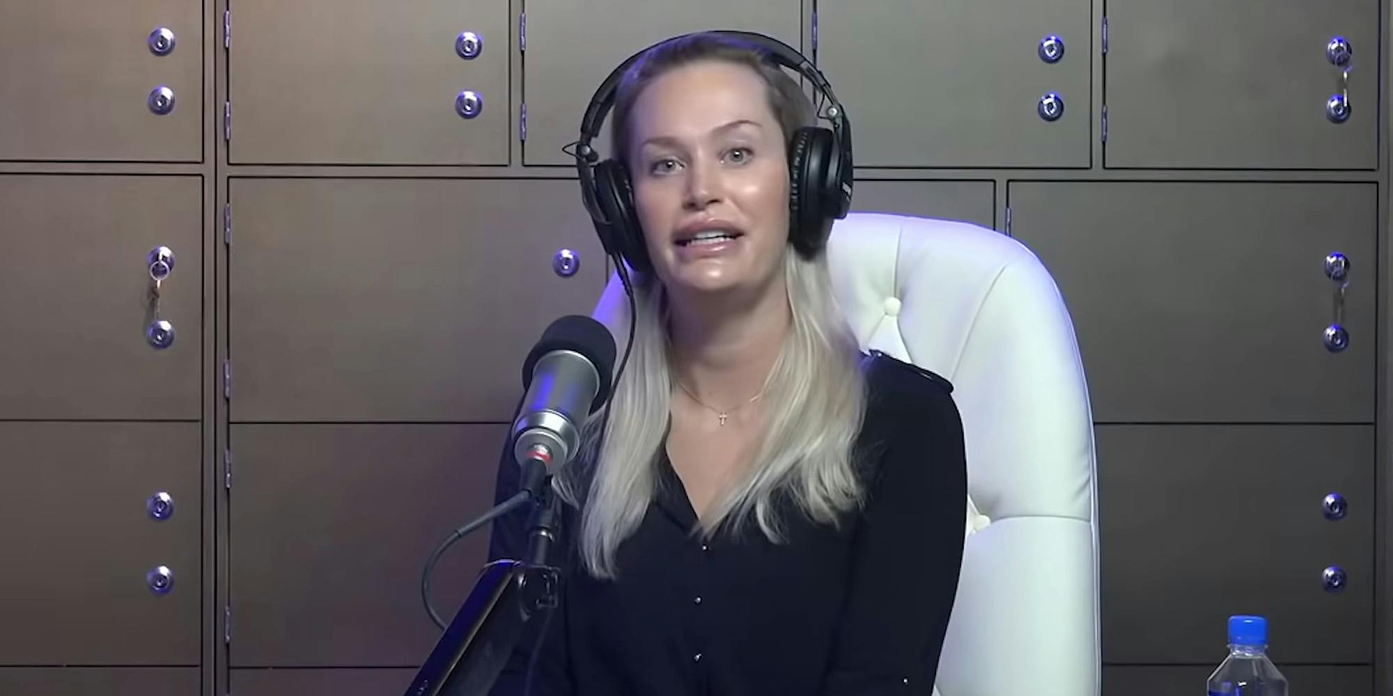 Christina Pushaw speaking into microphone while sitting in chair