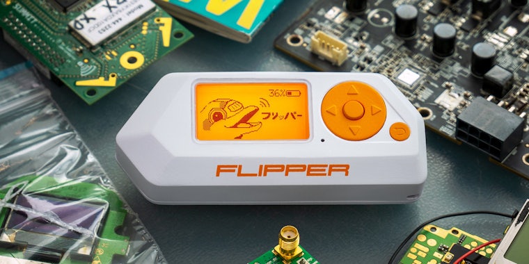 Flipper portable multi-tool device with circuits around on grey surface