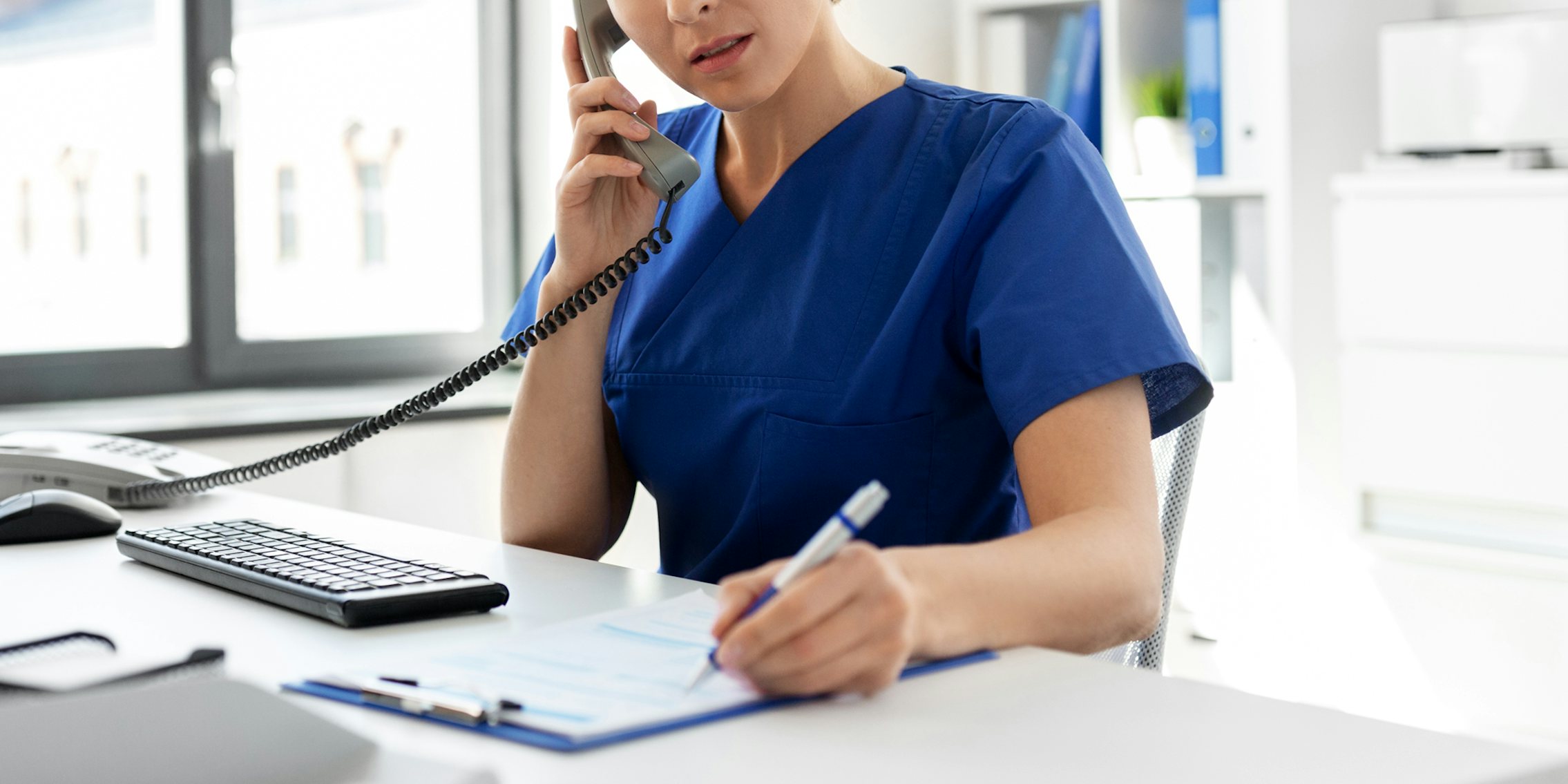 nurse calling on phone at desk