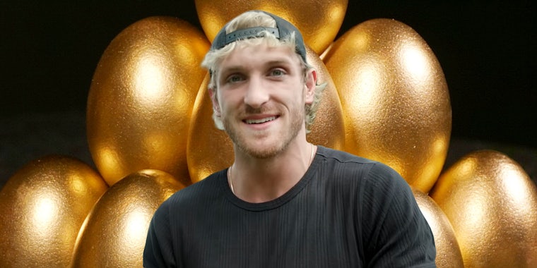 Logan Paul in front of golden eggs stacked in front of black background