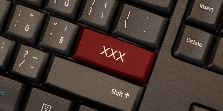 grey computer keyboard with XXX red button replacing enter button