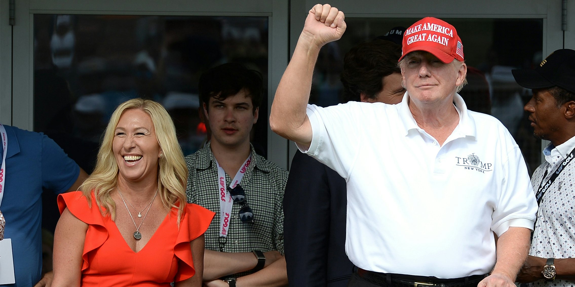 BEDMINSTER,NJ-JULY 31,2022: Marjorie Taylor Greene (L) with Former President Trump react to the golf fans at the 16th Hole during the LIV Tournament held at Trump National Golf Club in Bedminster,NJ.