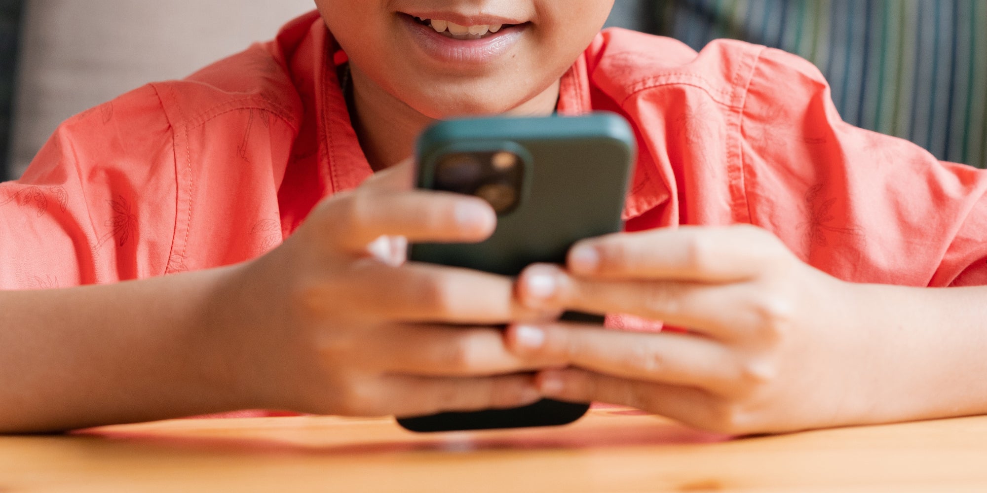 child using chatgpt for kids on phone at table