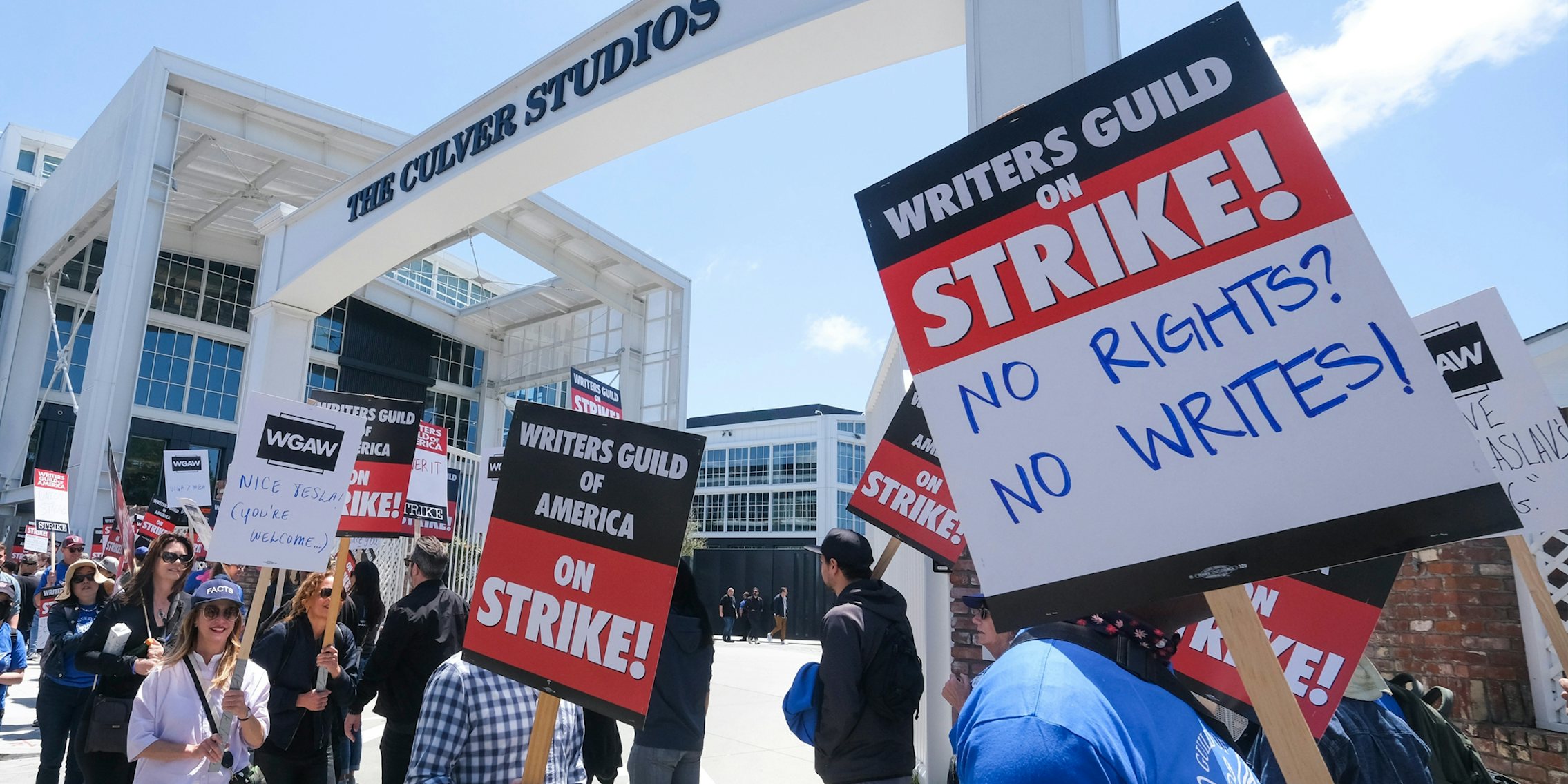 Members of WGA walk with pickets on strike outside Culver Studios