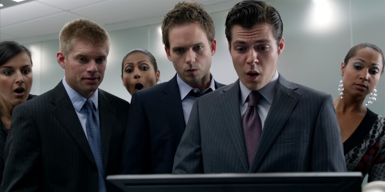 people in office looking surprised at monitor