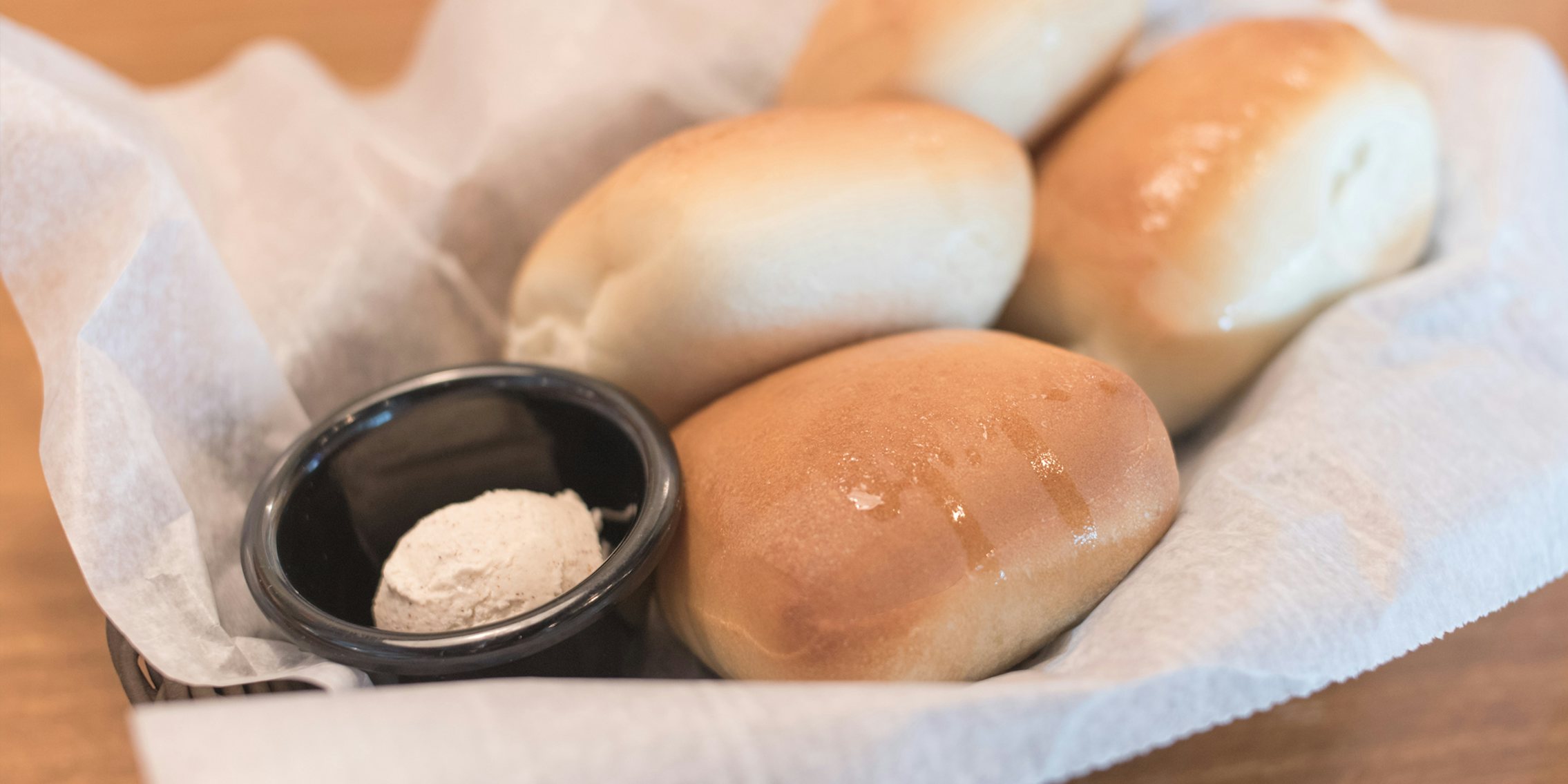 Texas Roadhouse rolls in basket with butter