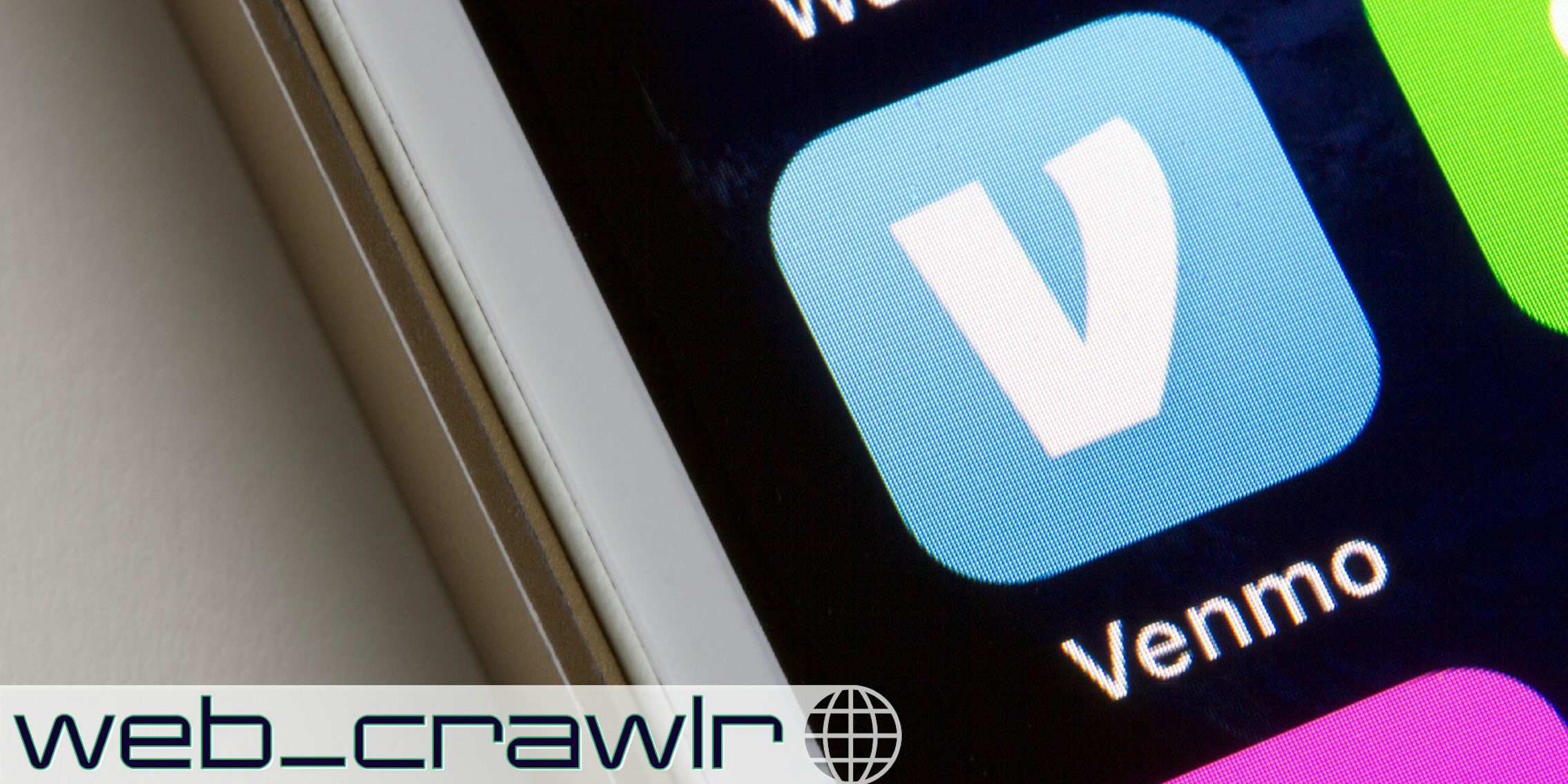 Venmo mobile app icon is seen on a smartphone. The Daily Dot newsletter web_crawlr logo is in the bottom left corner.