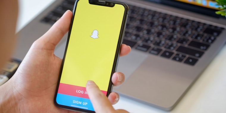 Woman holding iphone with snapchat app open