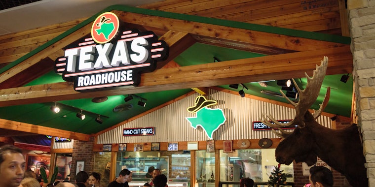 Texas Roadhouse interior with customers and sign