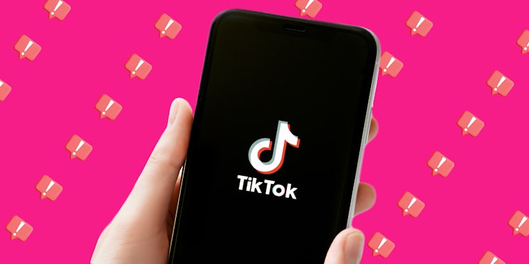 hand holding phone with TikTok app open on screen in front of pink background with emergency messages pattern