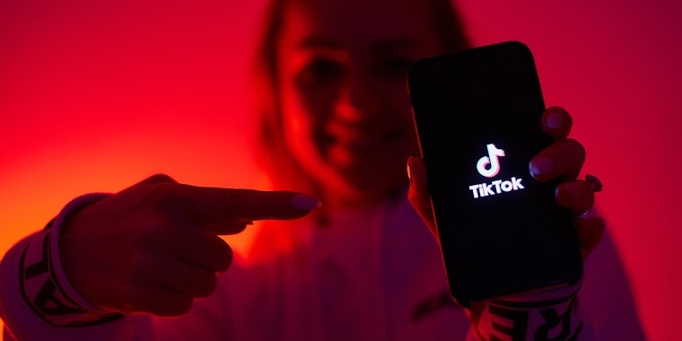 How much is a Galaxy on TikTok? A girl with the dark side tiktok promoting social network with a smartphone in hand.