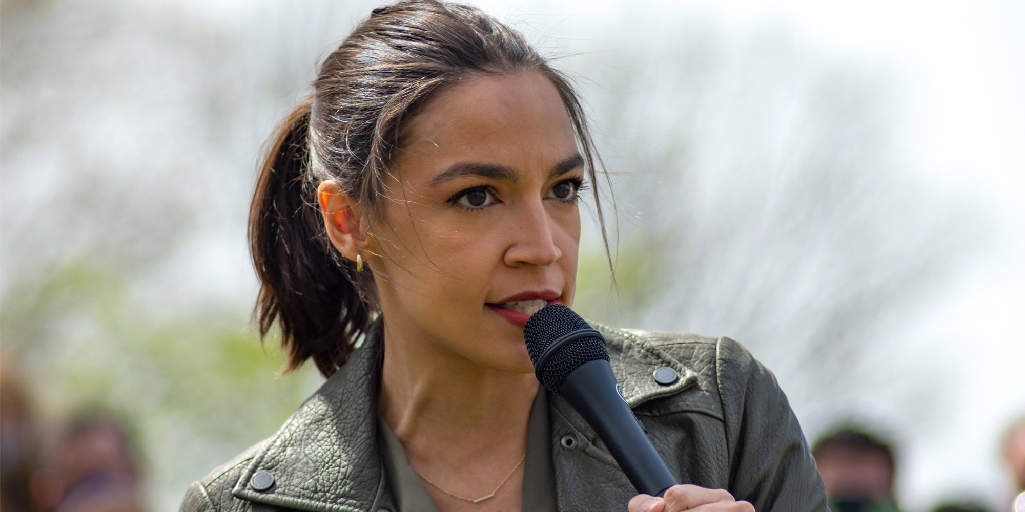 Congresswoman Alexandria Ocasio-Cortez Speaking into a microphone