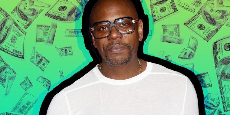 Dave Chappelle in front of floating money