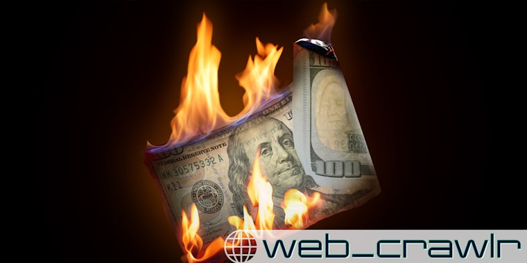 A $100 bill burning. The Daily Dot newsletter web_crawlr logo is in the bottom right corner.