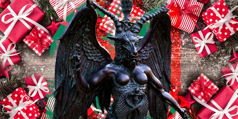 Satan statue surrounded by christmas gifts