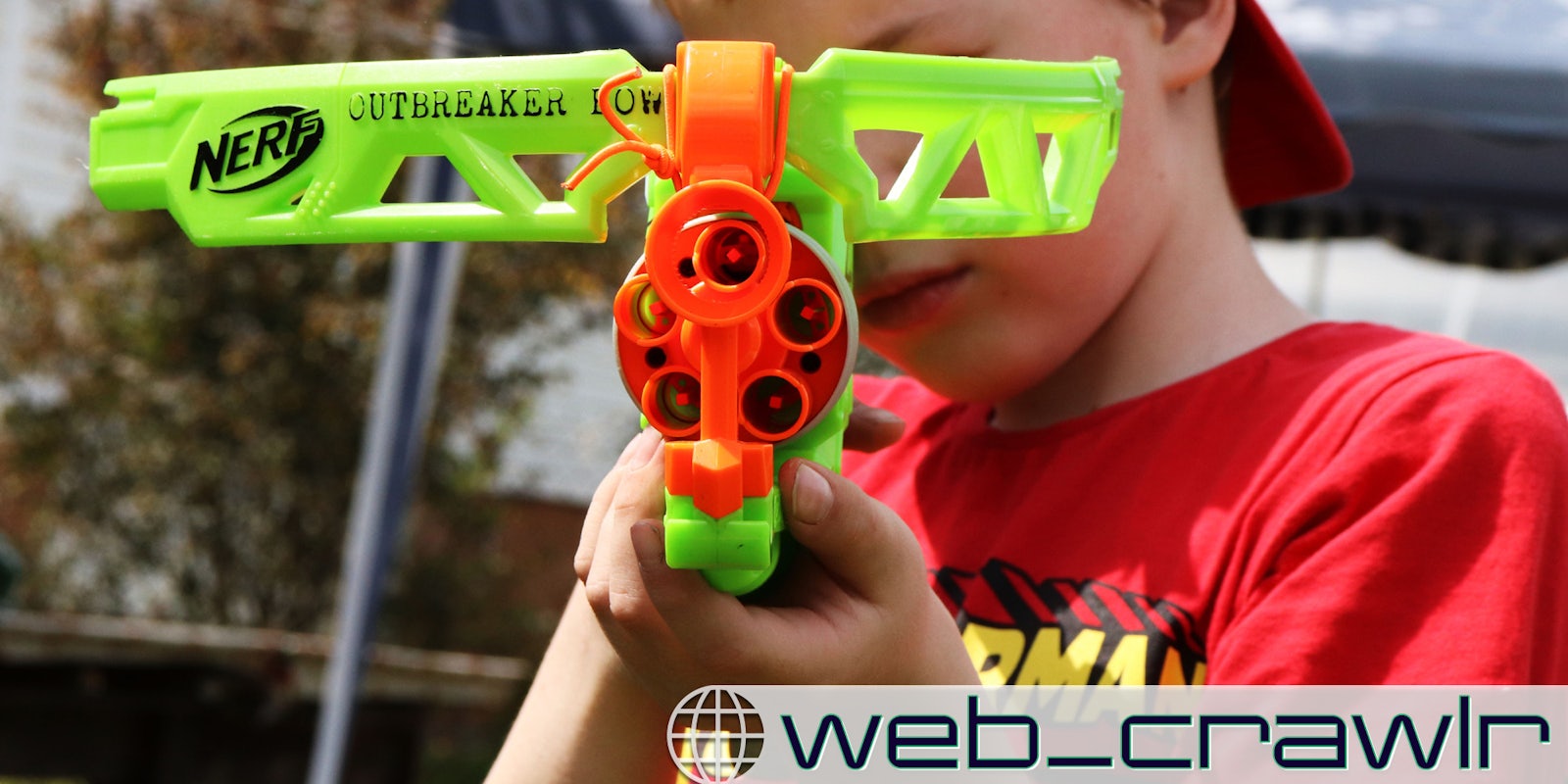 A kid holding a Nerf gun. The Daily Dot newsletter web_crawlr logo is in the bottom right corner.