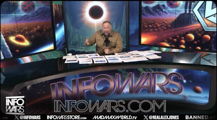 alex jones in front of his Infowars set