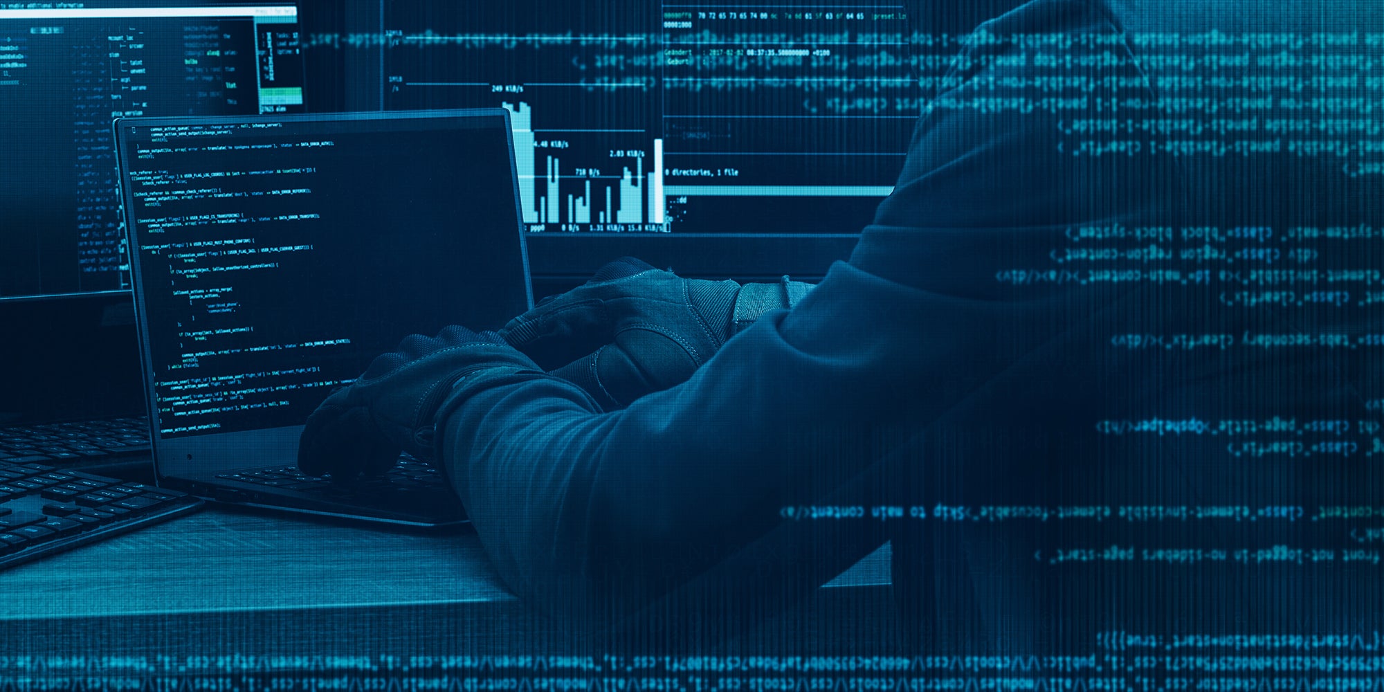 Hacker working on a code on dark digital background with digital interface around.