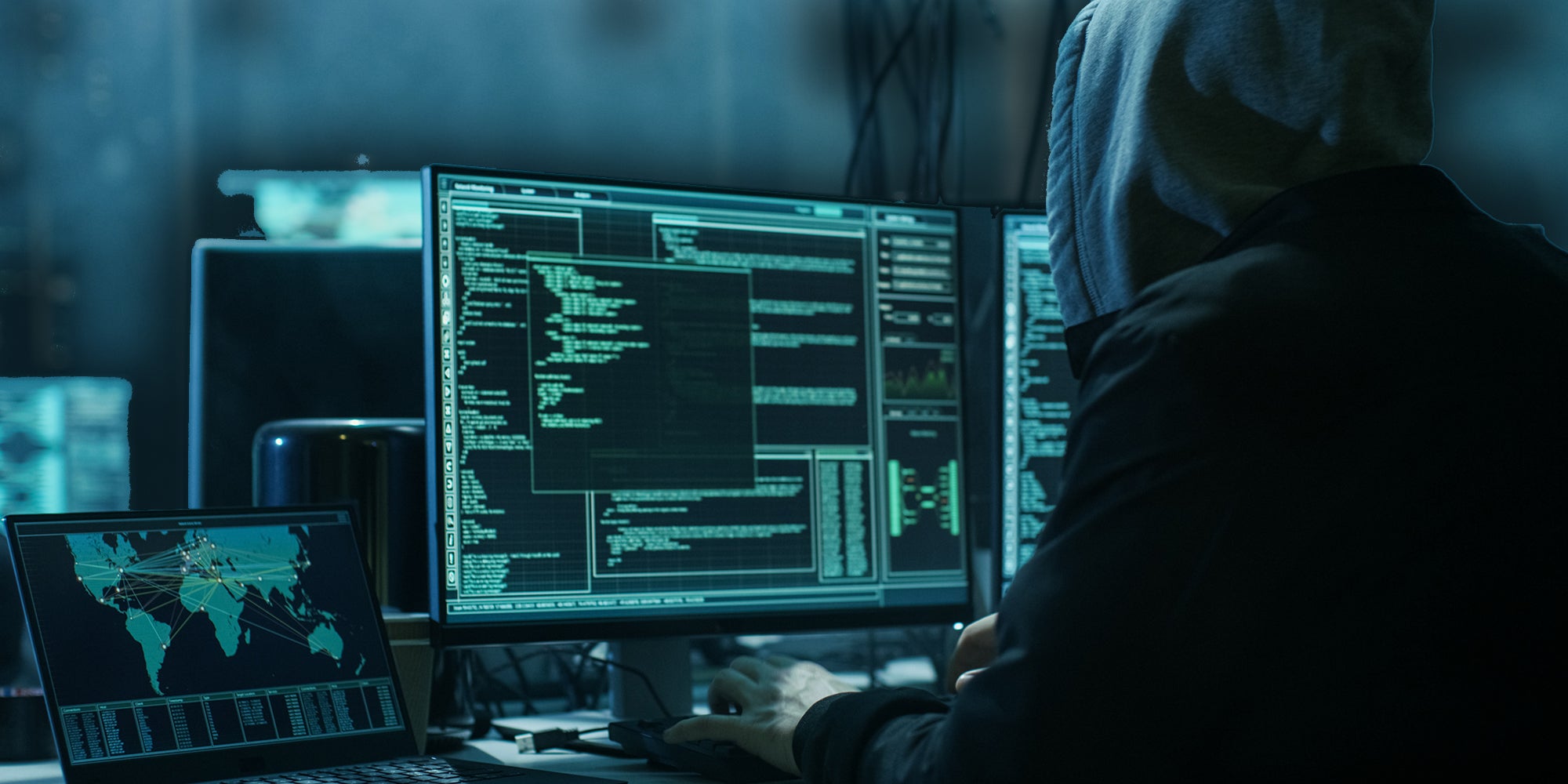 Dangerous Hooded Hacker Breaks into Government Data Servers and Infects Their System with a Virus. His Hideout Place has Dark Atmosphere, Multiple Displays, Cables Everywhere.