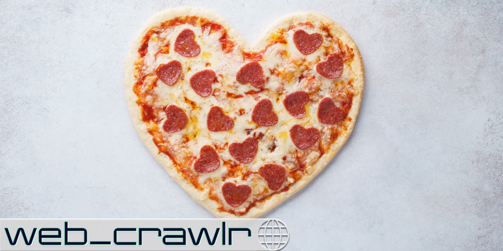 A heart-shaped pizza. The Daily Dot newsletter web_crawlr logo is in the bottom left corner.