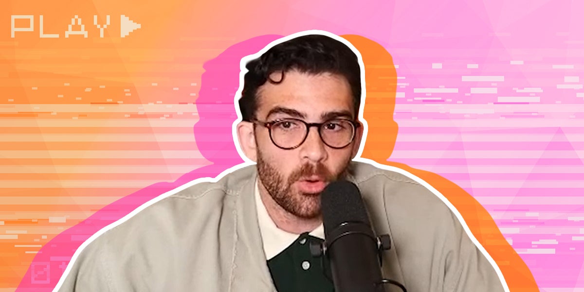 hasan piker interview speaking into a microphone with a video playing in the background