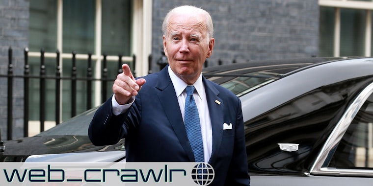 President Joe Biden pointing next to a car. The Daily Dot newsletter web_crawlr logo is in the bottom left corner.