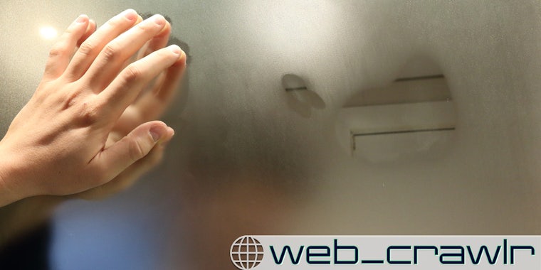A person's hand on a foggy mirror. The Daily Dot newsletter web_crawlr logo is in the bottom right corner.
