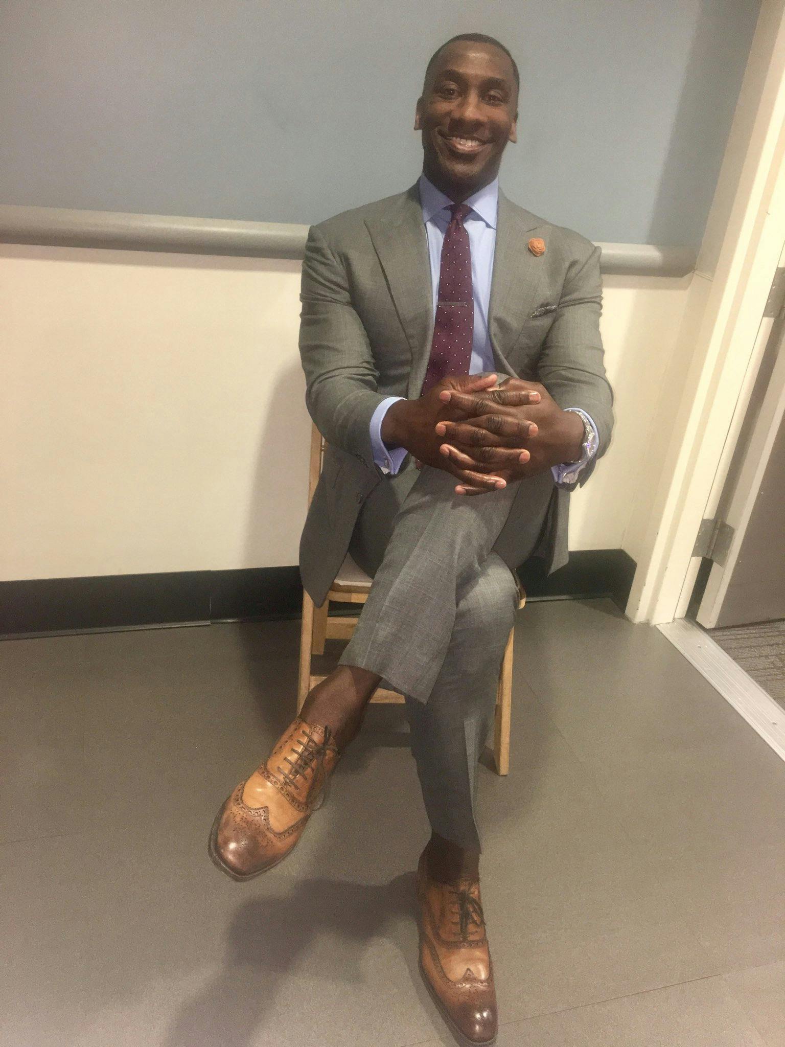 Shannon Sharpe meme - Sharpe seated wearing a suit