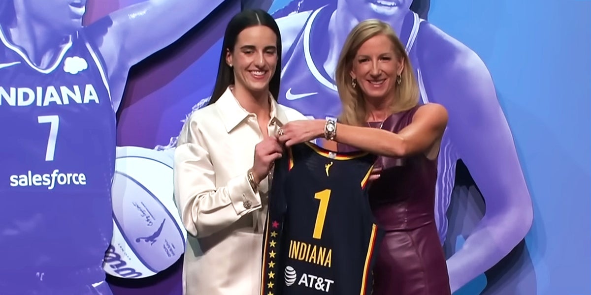 Caitlin Clark holding Indiana Fever Jersey