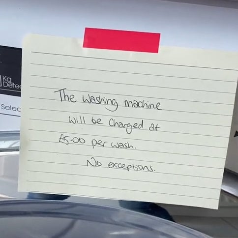 Handwritten note that reads 'The washing machine will be charged at £5.00 per wash. No exceptions.'