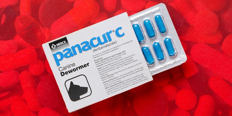 box of panacur c over background of pills