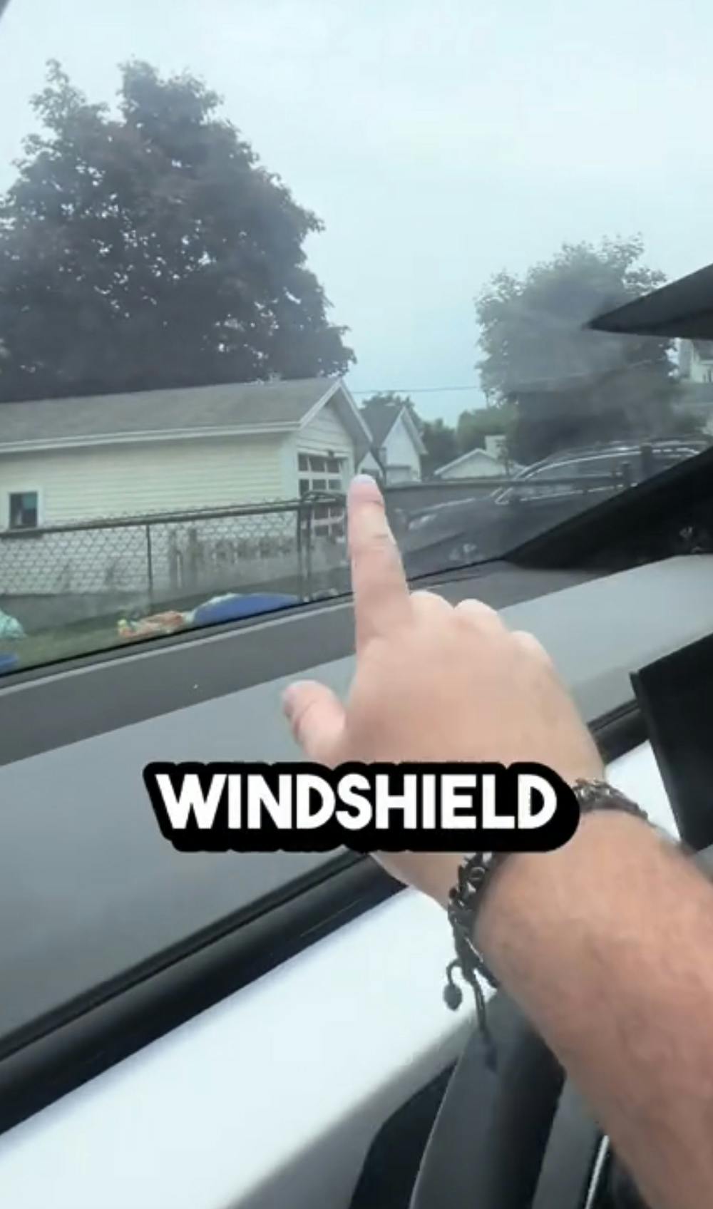 Finger pointing to windshield