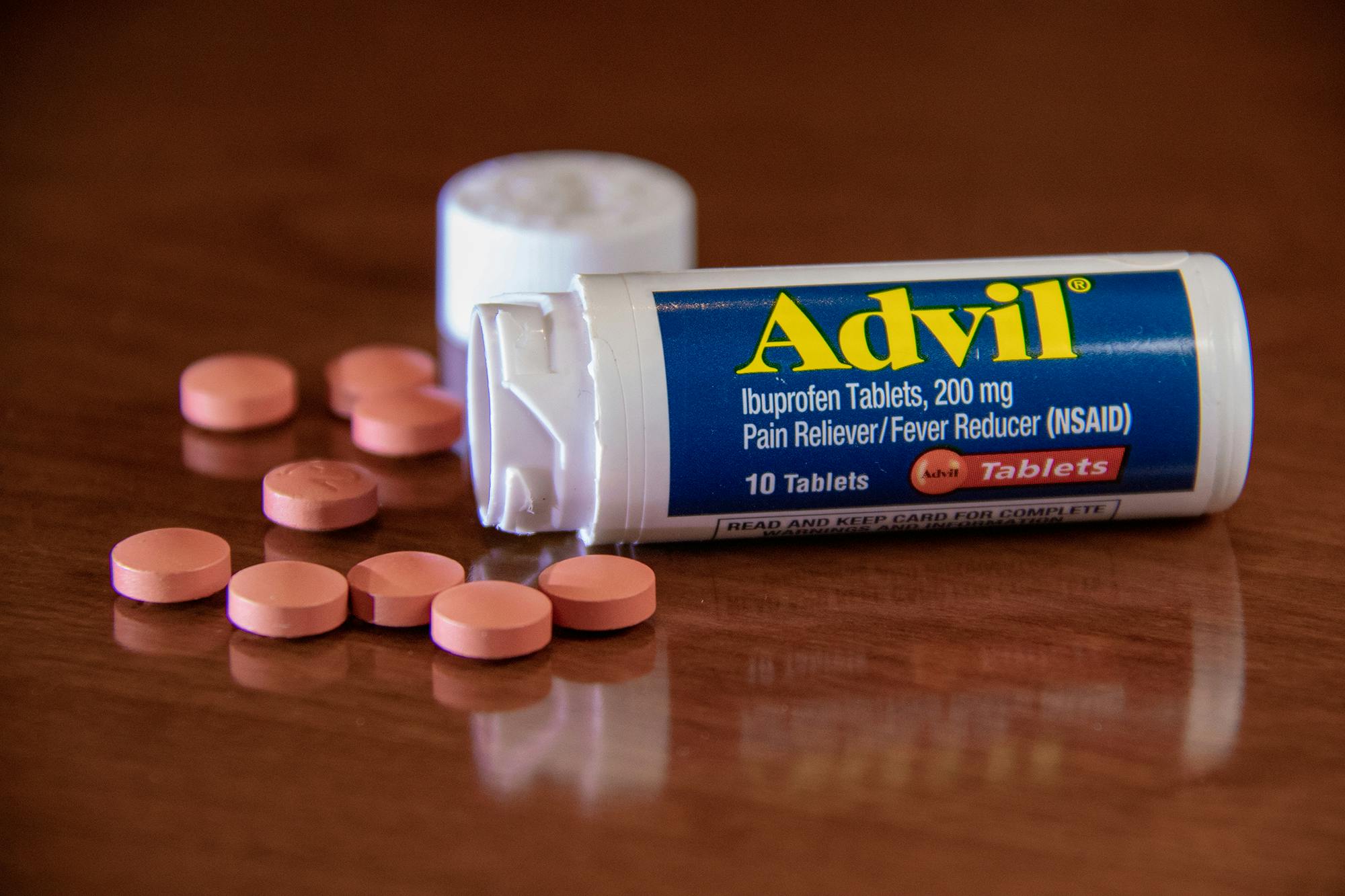 small Jar of Advil and Accompanying Pills