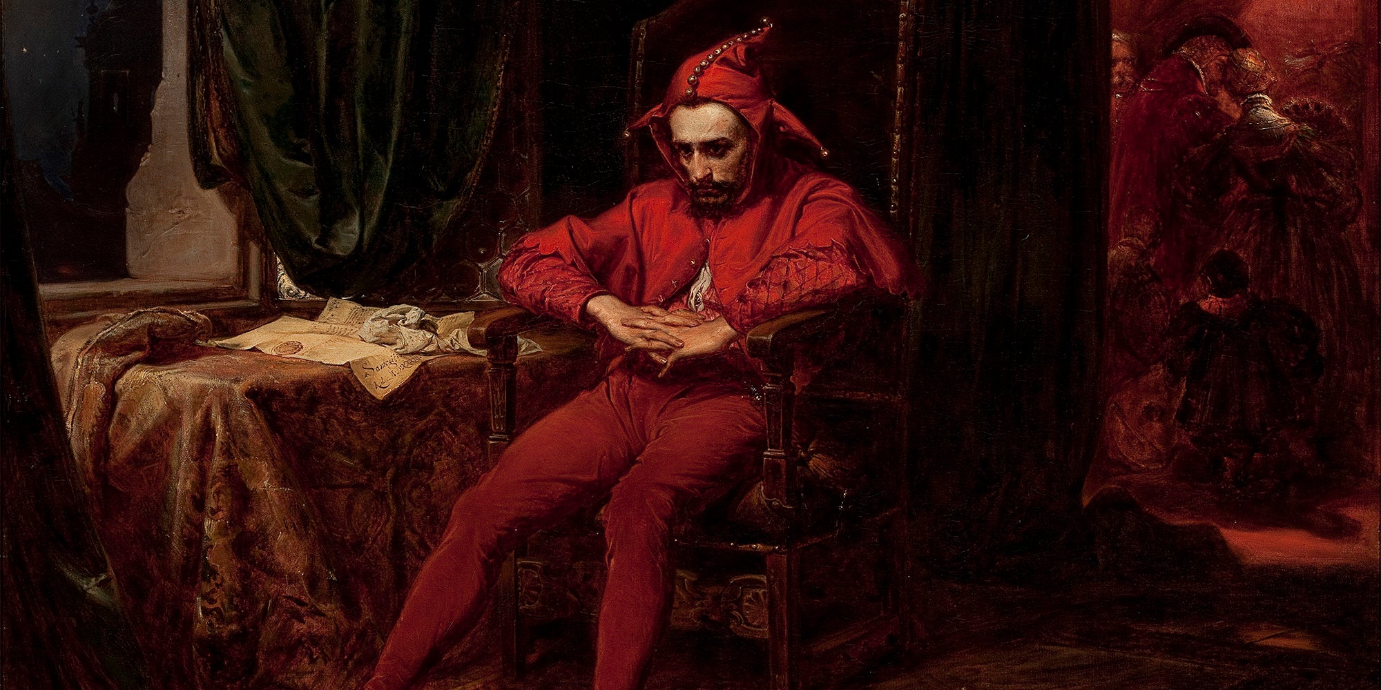 red jester sitting in chair