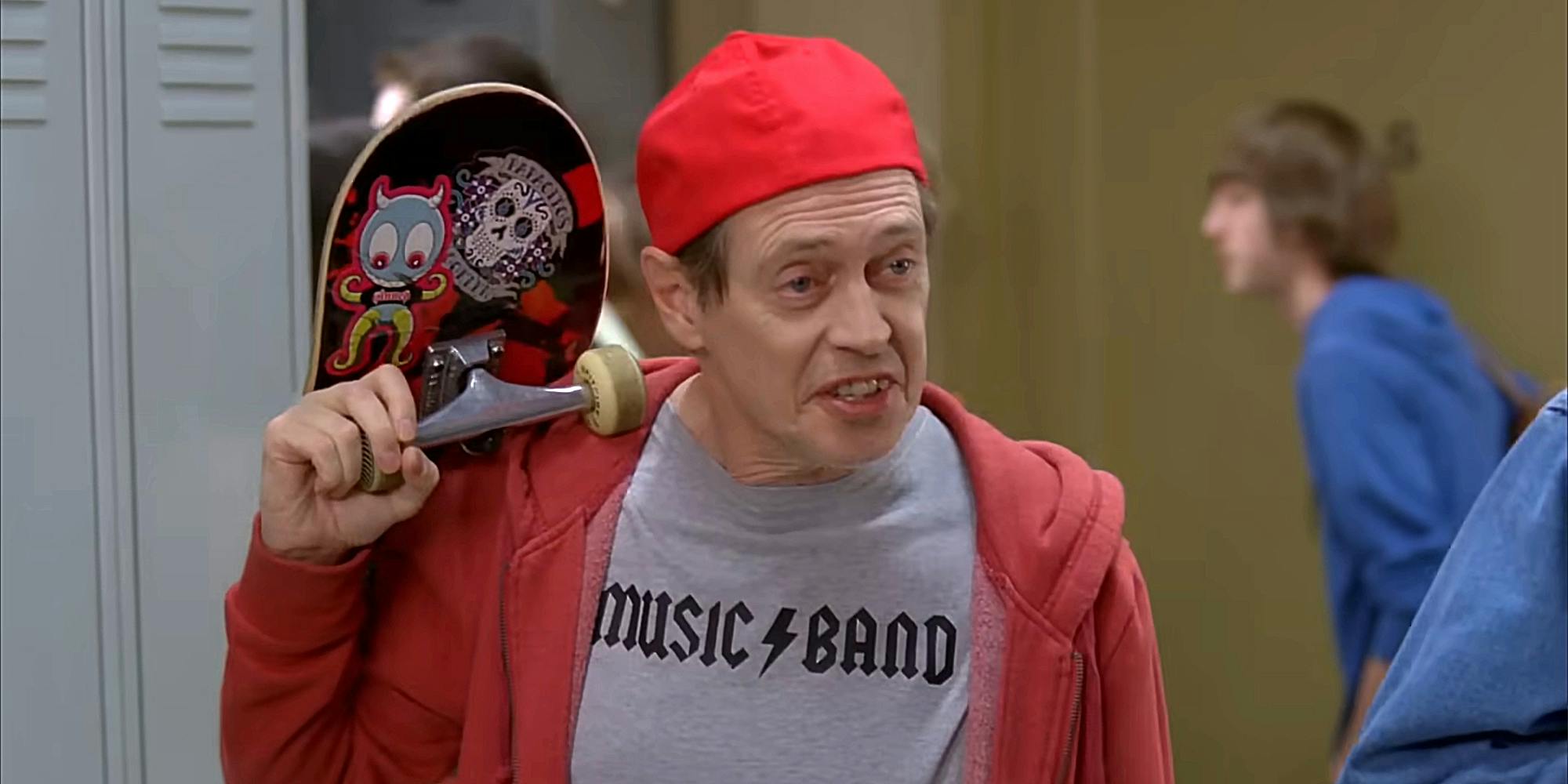 steve buscemi wearing "music band" t-shirt and carrying a skateboard