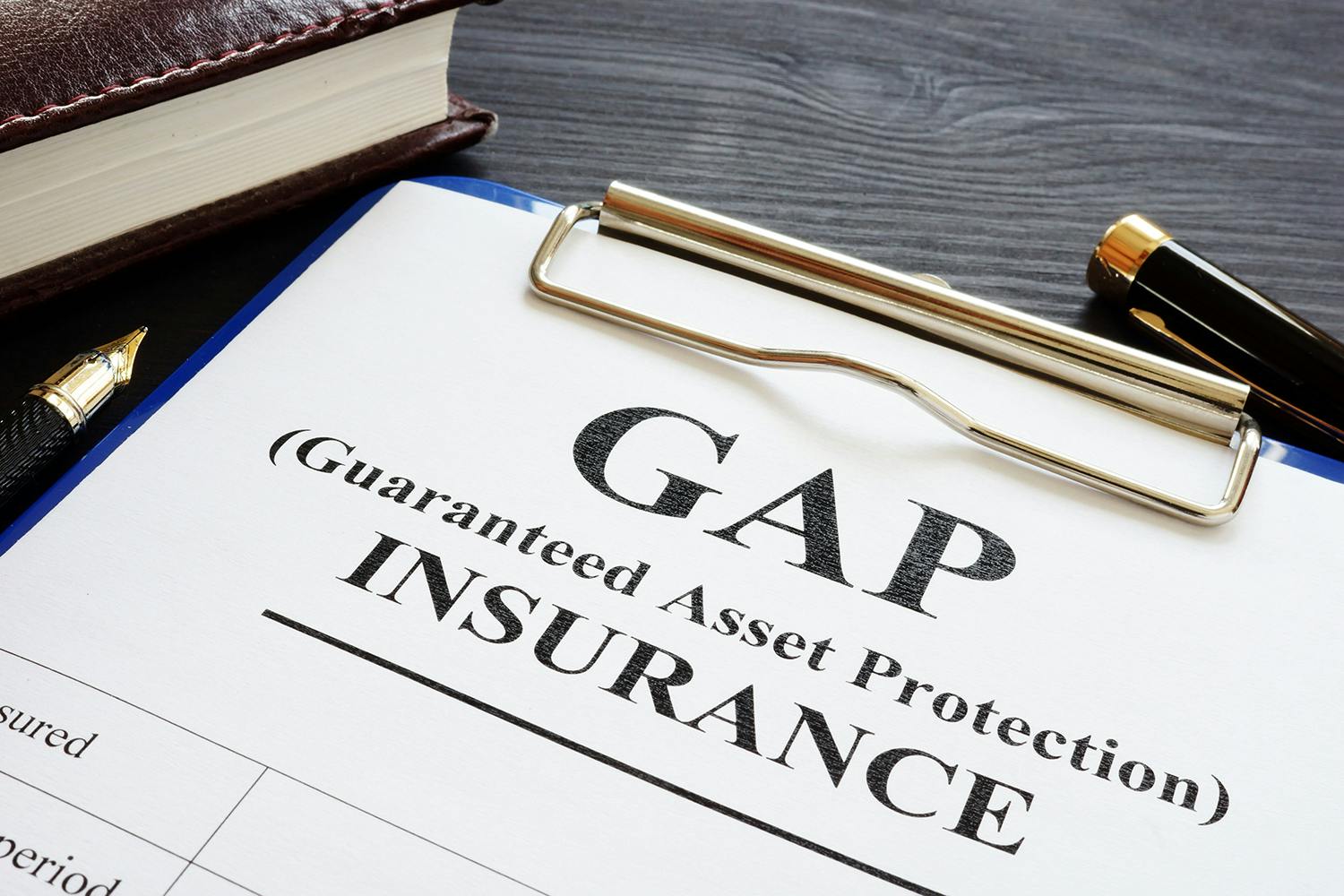 GAP (Guaranteed Asset Protection) insurance on clipboard with pens