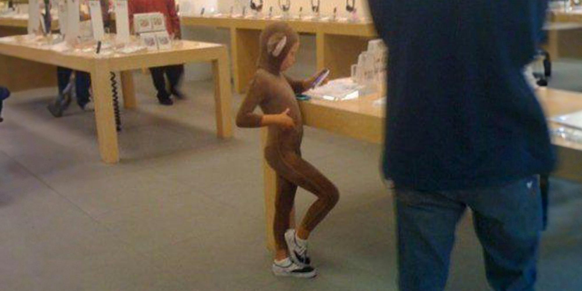 child in monkey suit standing in apple store