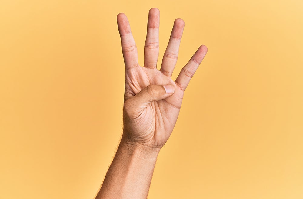 Arm and hand of caucasian man over yellow isolated background counting number 4 showing four fingers