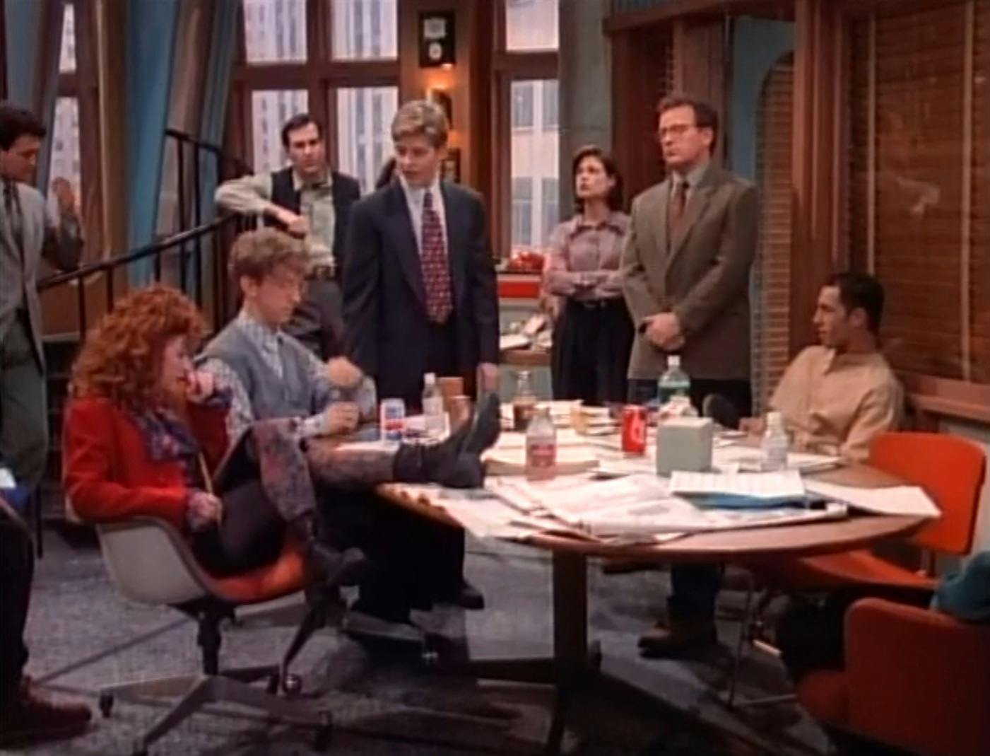 The cast of NewsRadio gathered in a staff meeting.