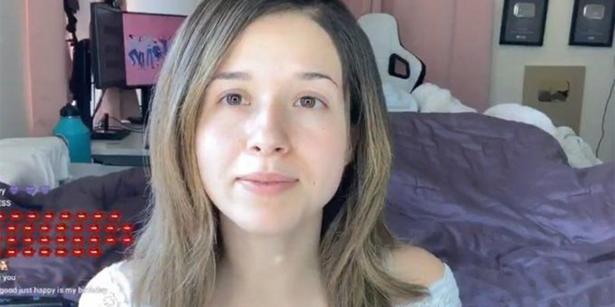 young woman sitting on bed