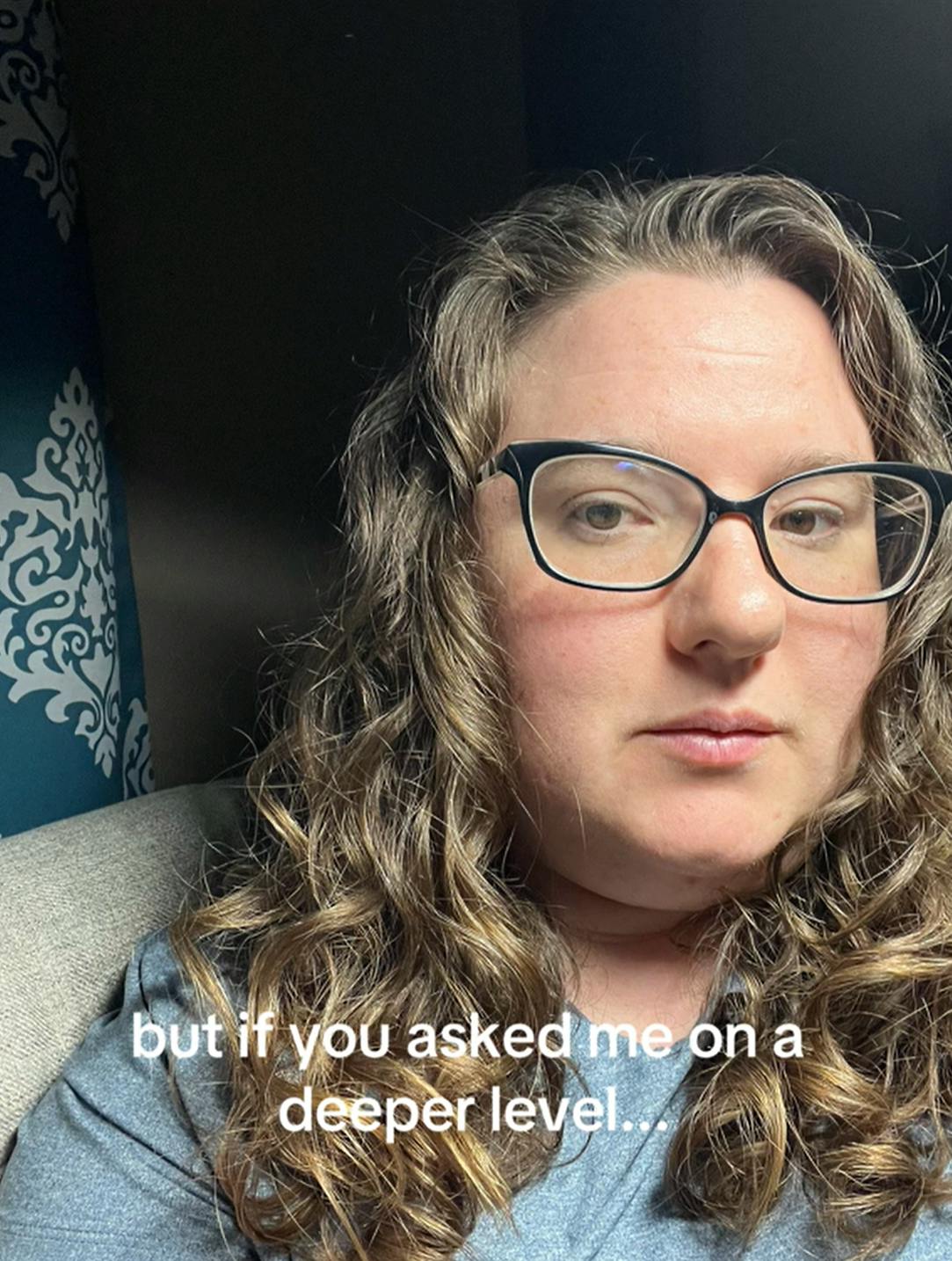 Selfie of a woman with curly hair and glasses. Text overlay reads, 'but if you asked me on a deeper level...'