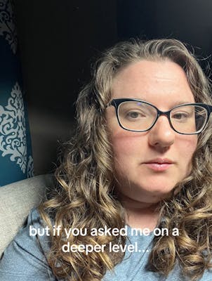 Selfie of a woman with curly hair and glasses. Text overlay reads, "but if you asked me on a deeper level..."