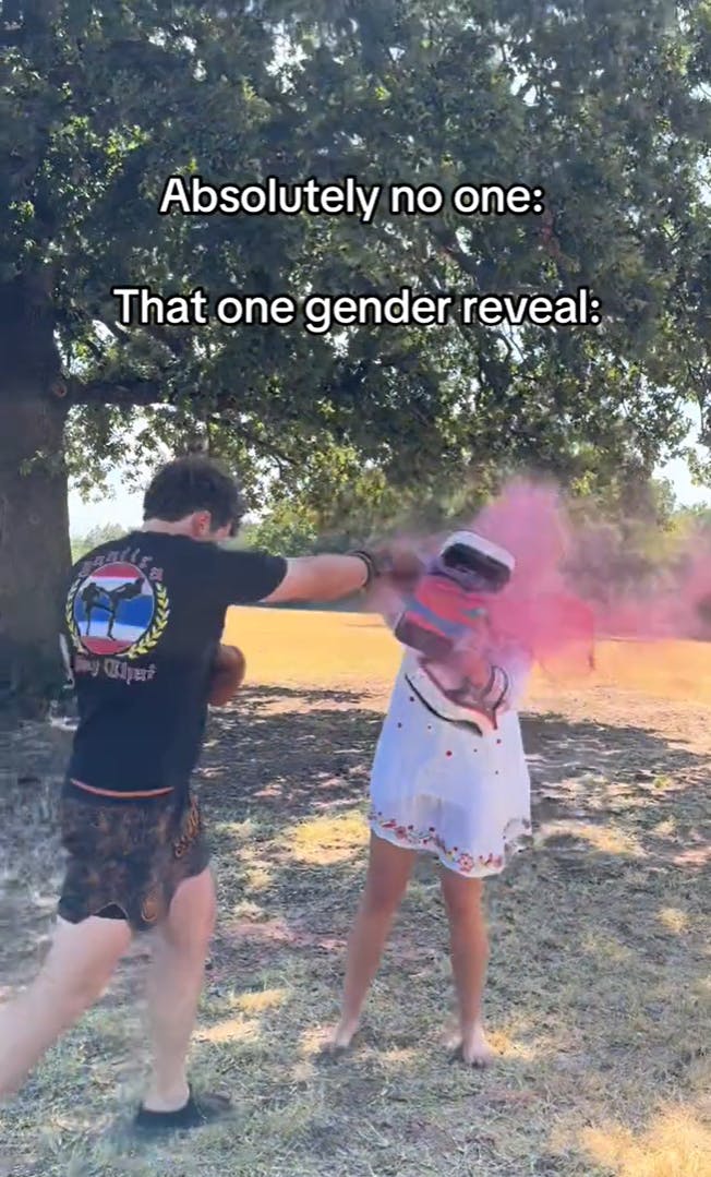 Parody video of a boxing gender reveal TikTok. The man is carefully punching his partner's strike mitts, revealing a poof of pink smoke. The text overlay reads, 'Absolutely no one: That one gender reveal:'