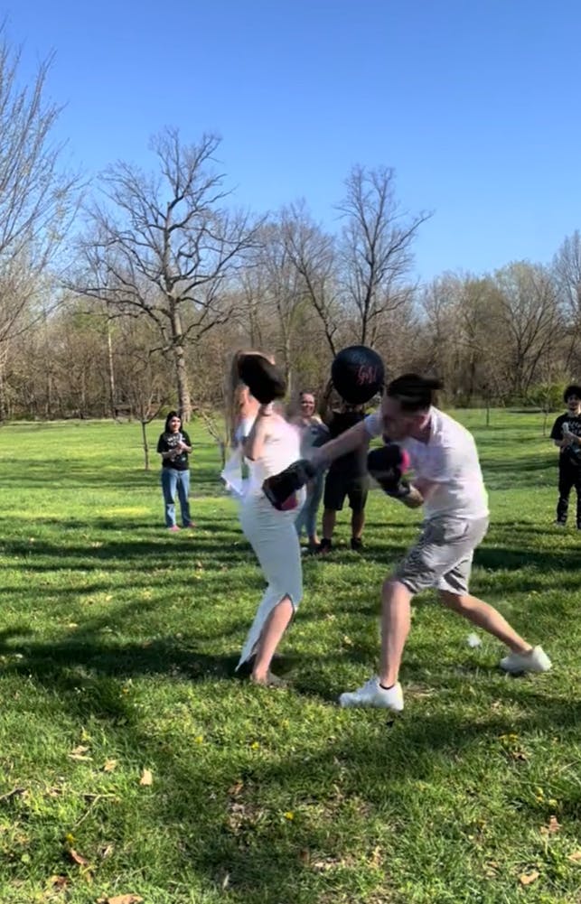 Video of a man putting way too much force behind his punches as he attempts to do a boxing gender reveal with his very pregnant partner, missing the strike mitt.
