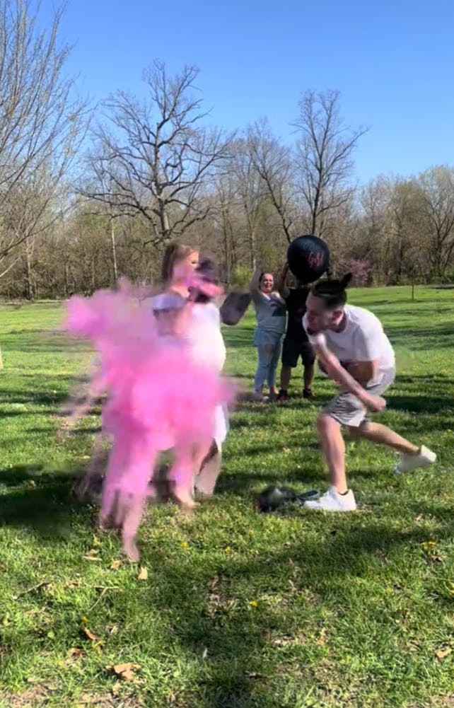 Video of a man putting way too much force behind his punches as he attempts to do a boxing gender reveal with his very pregnant partner, revealing a cloud of pink with his ungloved punch.
