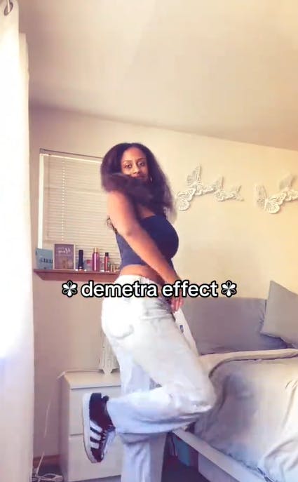 A young woman showing off her outfit with the text overlay, 'demetra effect'