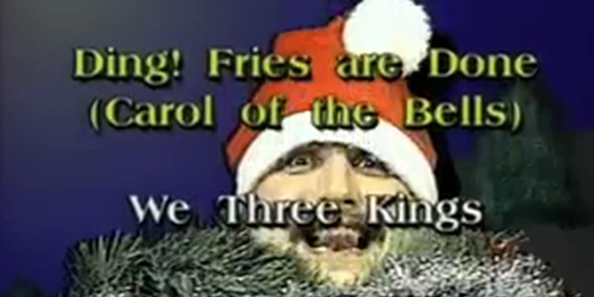 Man wearing Santa hat with "Ding! Fries are Done (Carol of the Bells)" and "We Three Kings" captions