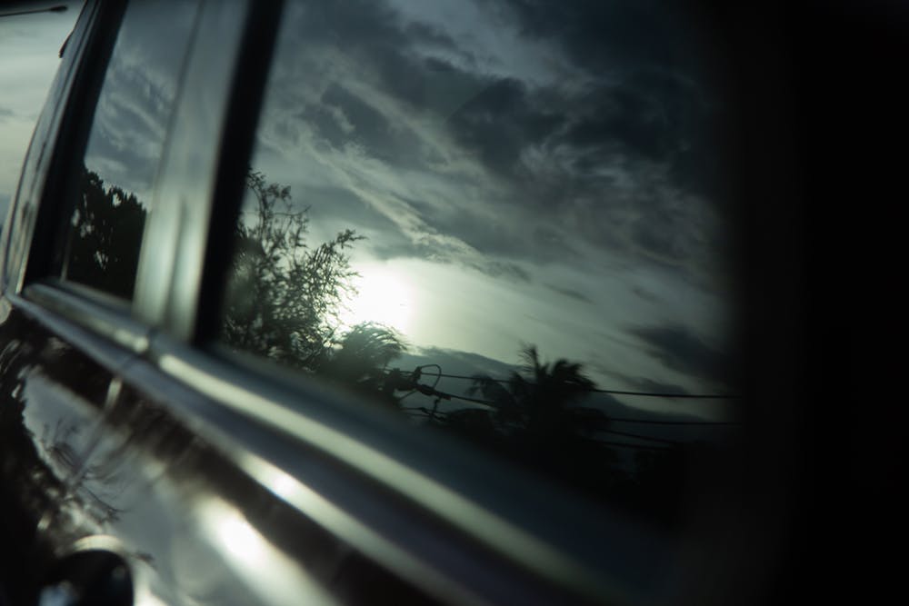 Black light film on the car glass, reflection of sunset sky at dusk, blur photo