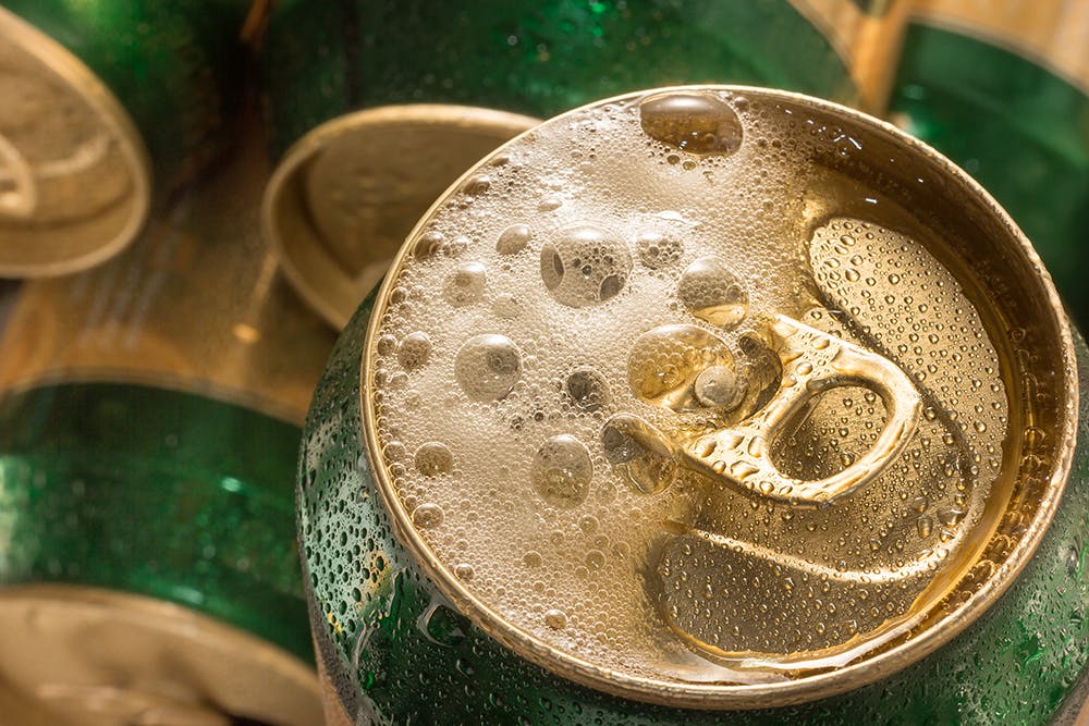 Close up cold can beer with foam.